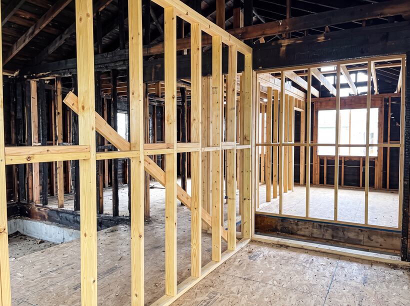 New framing and structural repairs against what survived.